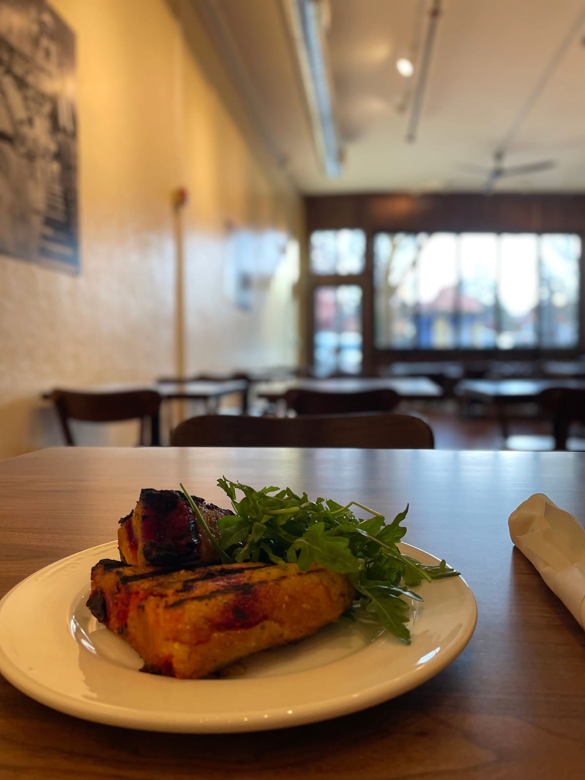 Grilled polenta slices with arugula, in the cafe dining room