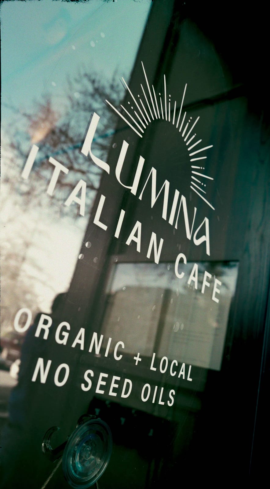 The cafe entrance window with the Lumina Italian Cafe decal